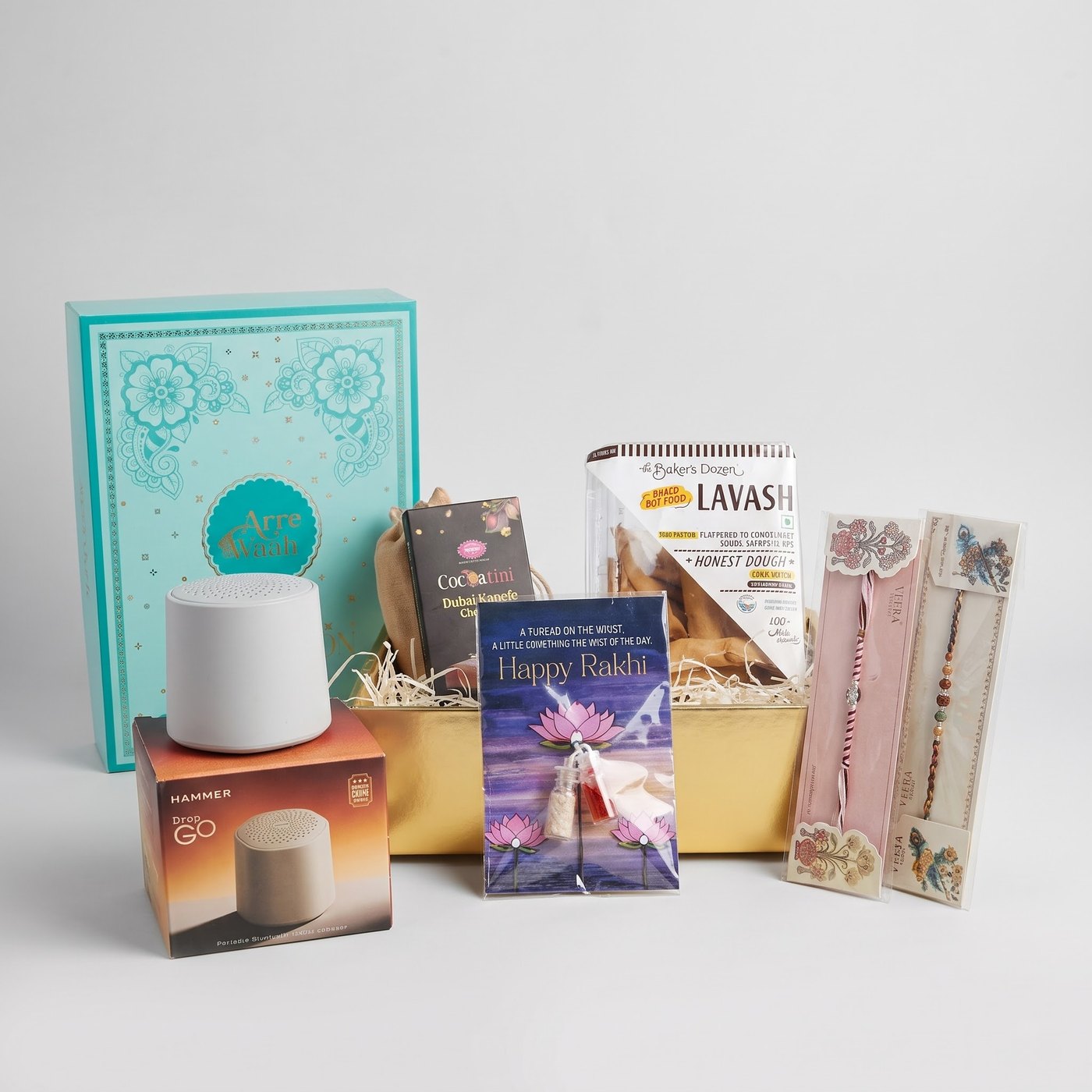 The Signature Box — Arre Waah Rakhi hamper with a bluetooth speaker, Dubai kunafa chocolate and two designer rakhis
